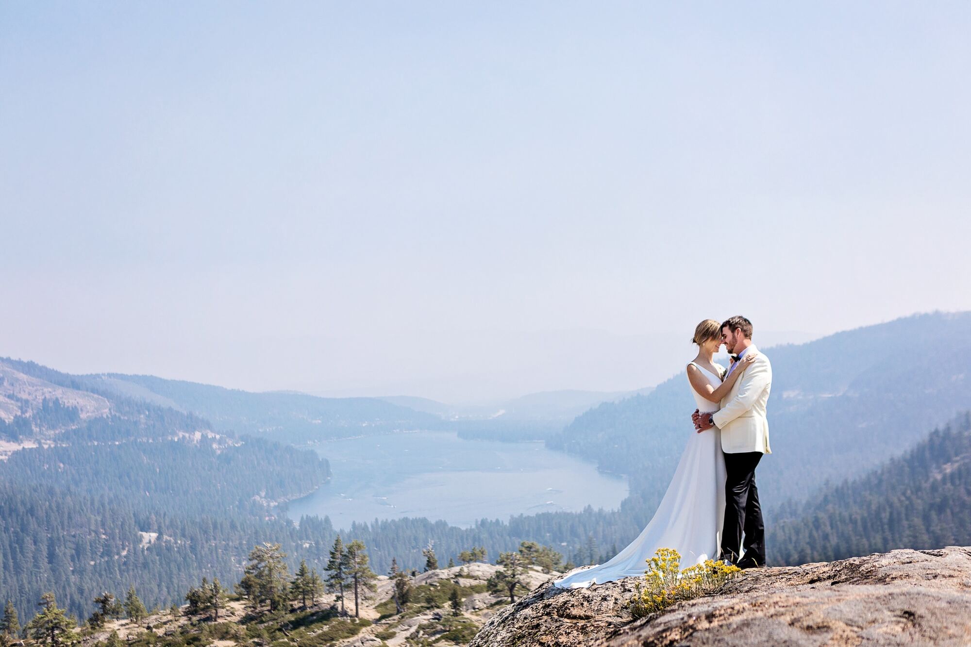 Wedding couple overlooking a sweeping Lake Tahoe mountain landscape